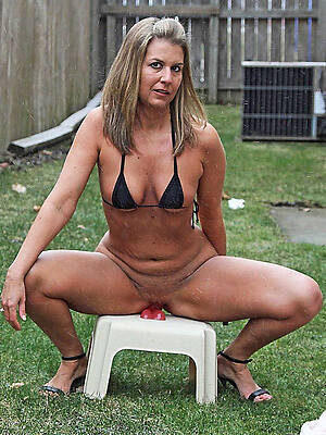 mature in bikinis showing her boobs